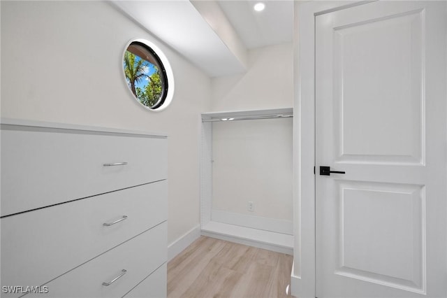 spacious closet with light hardwood / wood-style flooring