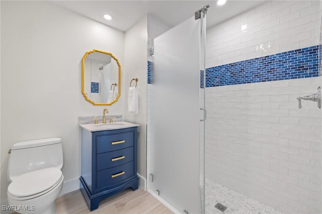 bathroom featuring walk in shower, vanity, and toilet