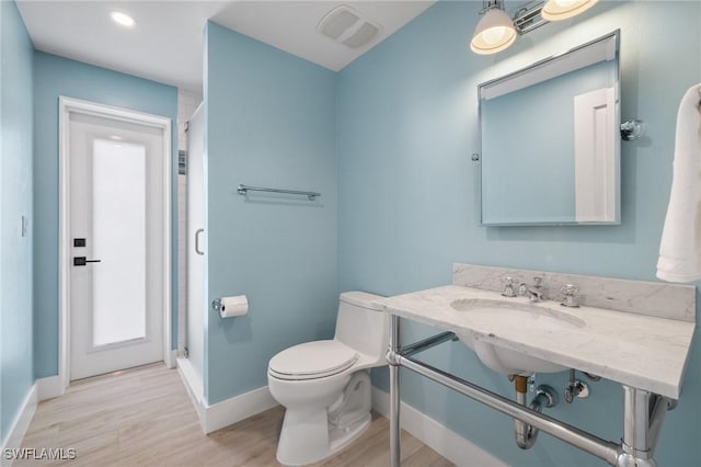 bathroom featuring hardwood / wood-style floors, toilet, and sink