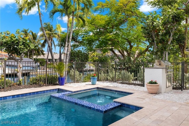 view of pool with an in ground hot tub and a water view