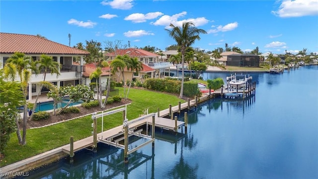 view of dock featuring a water view, a yard, and a swimming pool