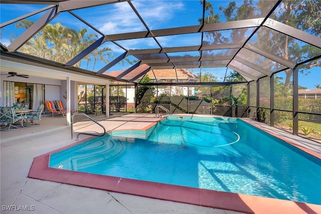 view of swimming pool featuring a patio area and glass enclosure