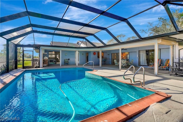 view of swimming pool featuring glass enclosure and a patio