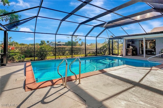 view of pool with a patio area and glass enclosure