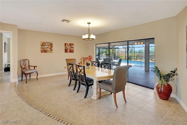 tiled dining room featuring a notable chandelier