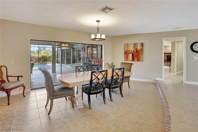 tiled dining space with a chandelier