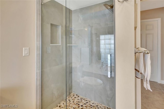 bathroom with a shower with door