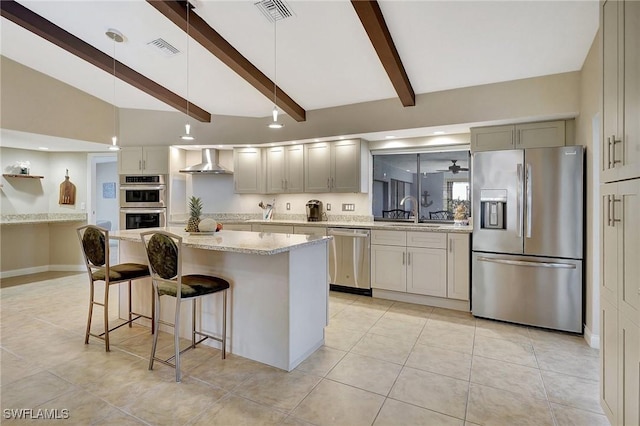 kitchen featuring a center island, wall chimney exhaust hood, stainless steel appliances, sink, and light stone counters