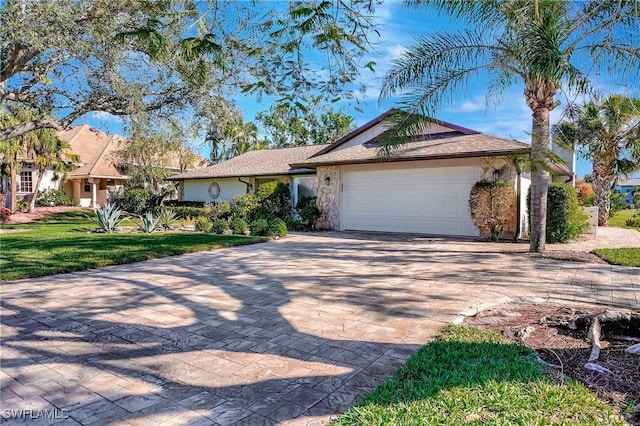 single story home with a front yard and a garage