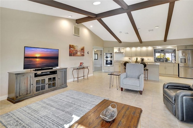 living room featuring beam ceiling, high vaulted ceiling, and light tile patterned floors