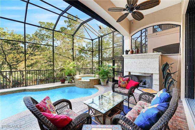 view of pool featuring a patio area, ceiling fan, a lanai, and an outdoor living space with a fireplace