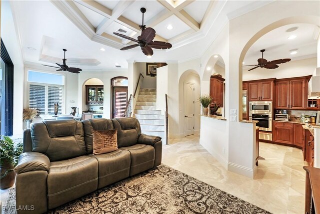 living room featuring ornamental molding, coffered ceiling, and beamed ceiling