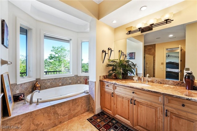 bathroom with shower with separate bathtub, tile patterned floors, and vanity