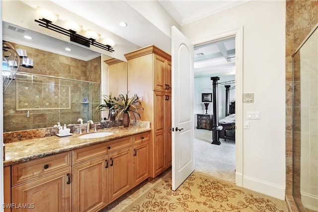 bathroom with a shower with door, ornamental molding, and vanity