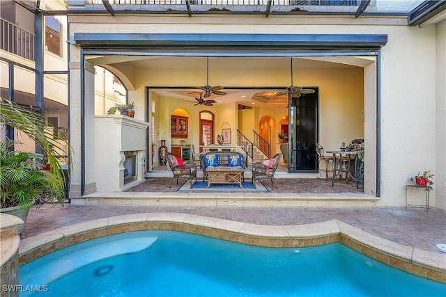 view of pool featuring ceiling fan, an outdoor hangout area, glass enclosure, and a patio