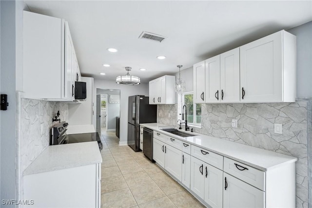 kitchen with white cabinets, light tile patterned floors, sink, and black appliances