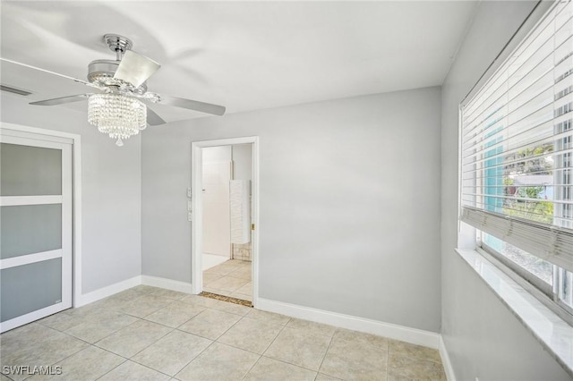 tiled empty room with ceiling fan