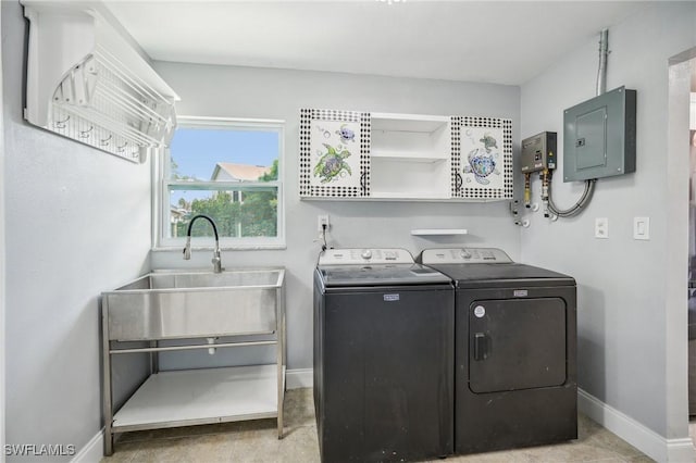 laundry room featuring electric panel, separate washer and dryer, and sink