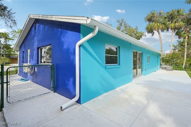 view of property exterior with a patio area