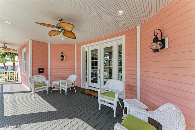 wooden terrace with covered porch, french doors, and ceiling fan