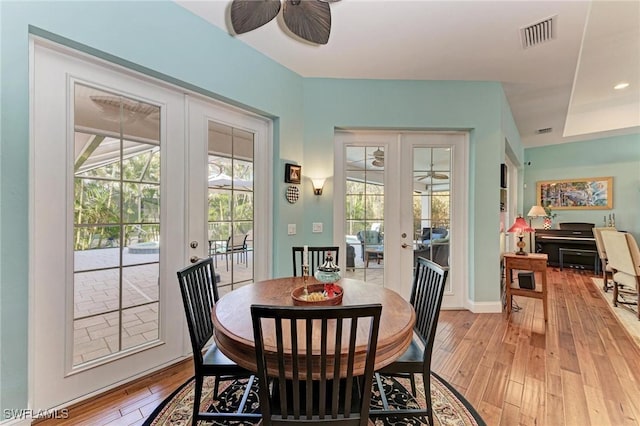 dining room with french doors and light hardwood / wood-style floors