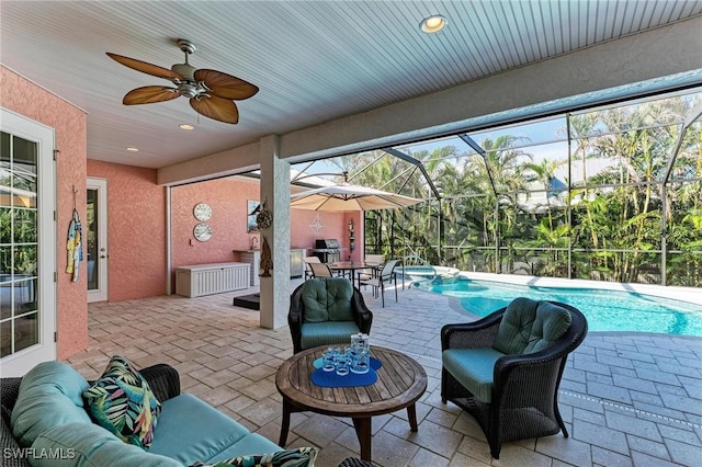 view of patio / terrace with an outdoor living space, ceiling fan, and glass enclosure