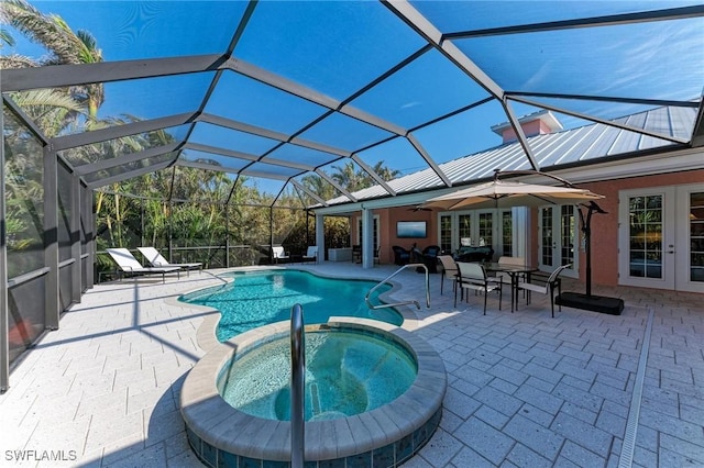 view of pool with glass enclosure, french doors, ceiling fan, an in ground hot tub, and a patio