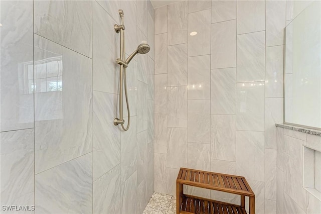 bathroom with a tile shower