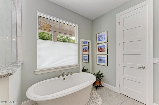 bathroom featuring tile patterned flooring and a bathtub