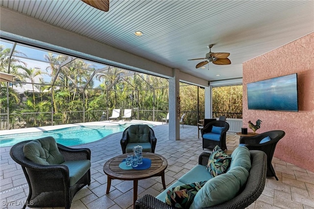 view of patio featuring an outdoor hangout area, a fenced in pool, glass enclosure, and ceiling fan