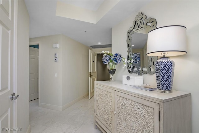 hallway featuring baseboards and recessed lighting
