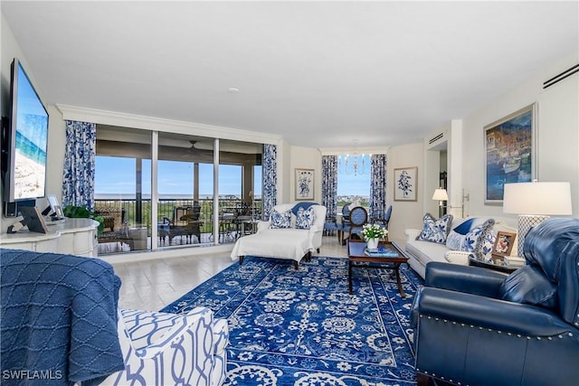 living room featuring hardwood / wood-style floors, expansive windows, and a chandelier