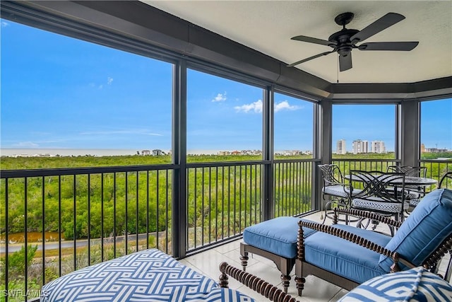 sunroom / solarium featuring ceiling fan