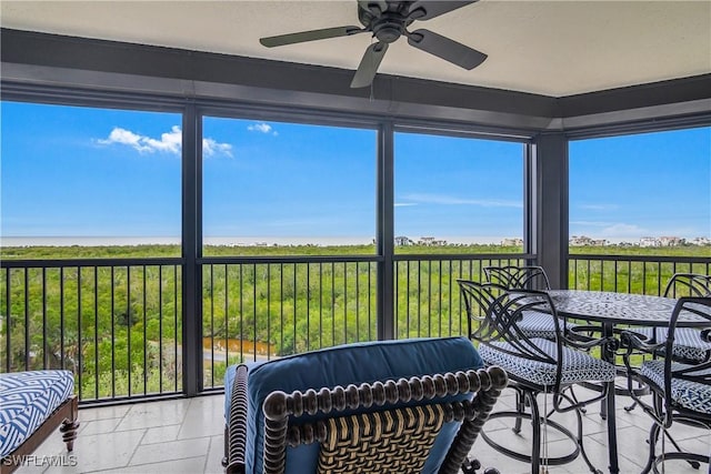 sunroom / solarium featuring ceiling fan