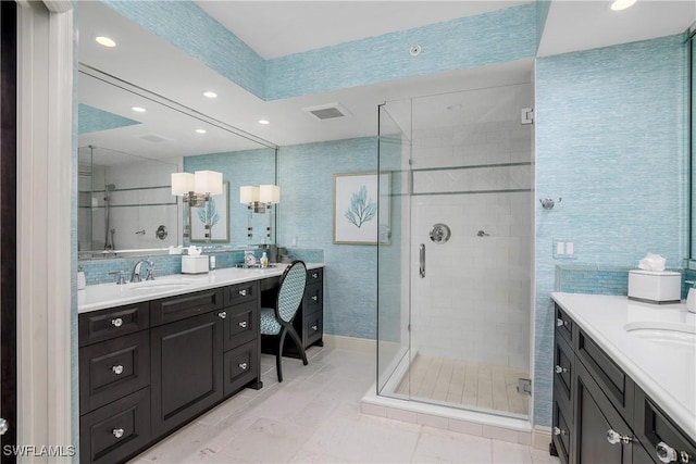 bathroom with tile patterned flooring, vanity, walk in shower, and tile walls