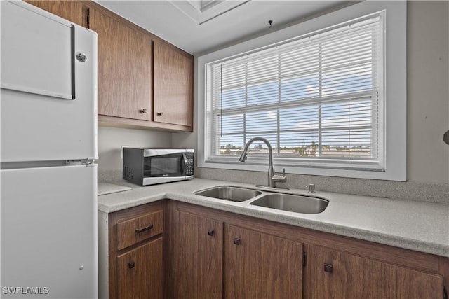 kitchen with white fridge and sink