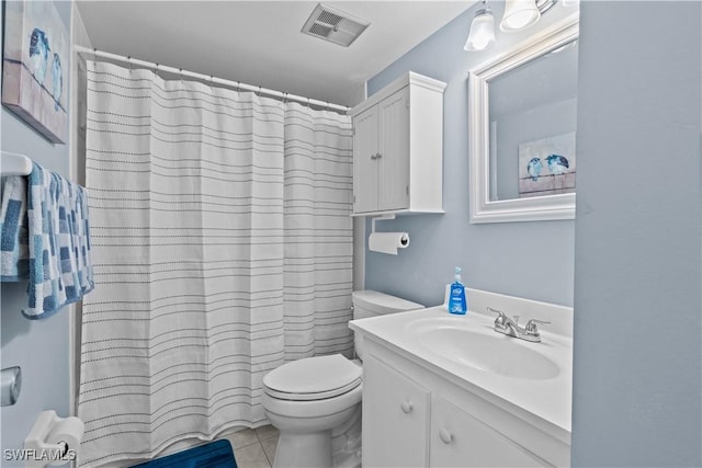 bathroom with toilet, vanity, tile patterned floors, and walk in shower