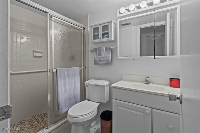 bathroom with vanity, toilet, and walk in shower