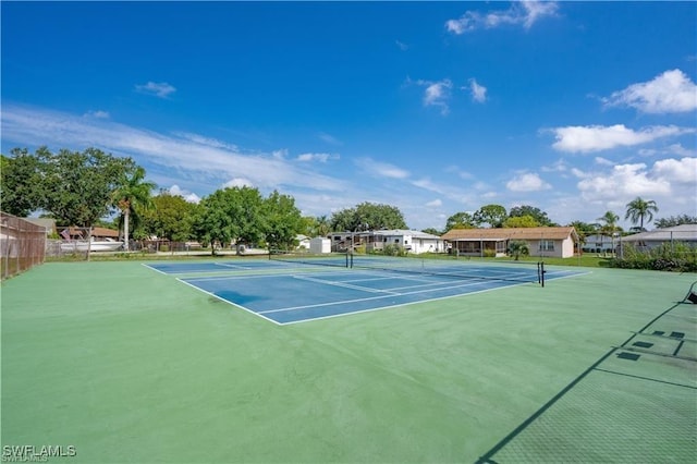 view of tennis court featuring basketball hoop