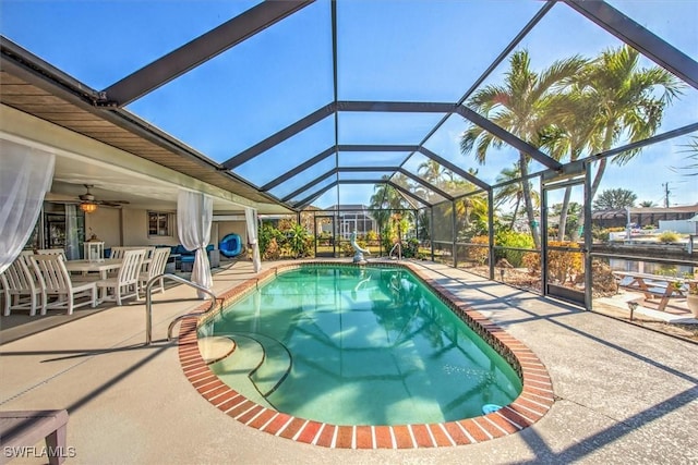 view of swimming pool featuring a patio area and glass enclosure