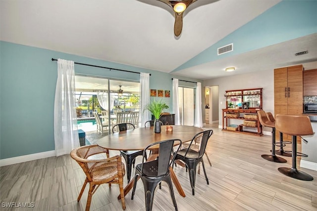 dining area with ceiling fan and vaulted ceiling