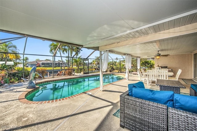 view of swimming pool featuring outdoor lounge area, ceiling fan, and a patio area