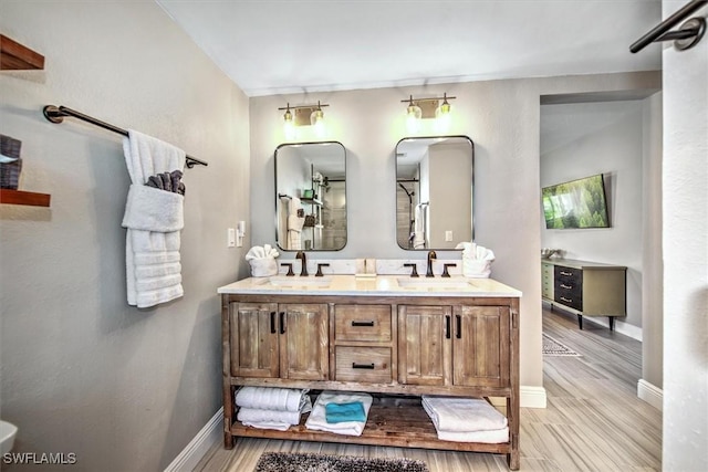 bathroom with wood-type flooring and vanity