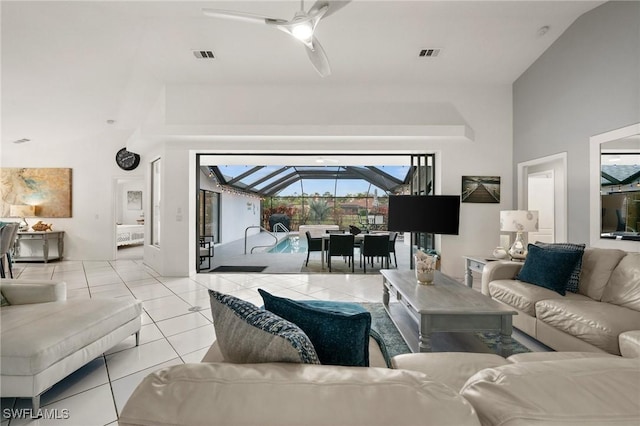 tiled living room featuring ceiling fan and lofted ceiling