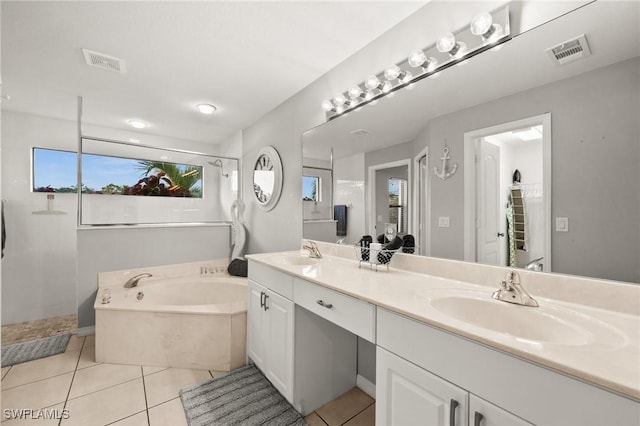 bathroom featuring plus walk in shower, tile patterned flooring, and vanity