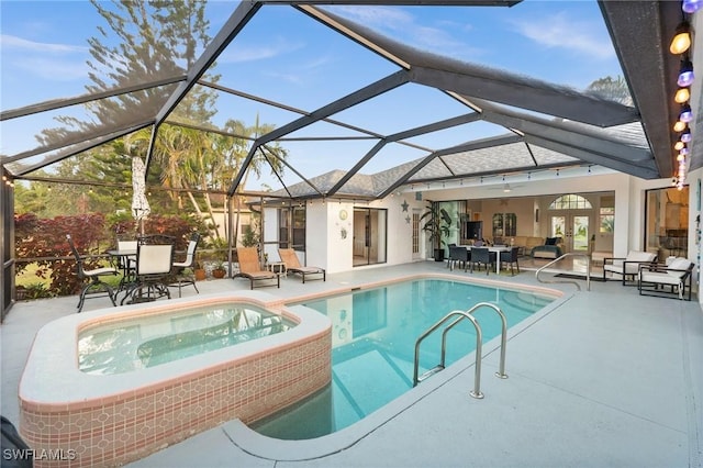 view of pool with a lanai, an in ground hot tub, a patio, and an outdoor hangout area