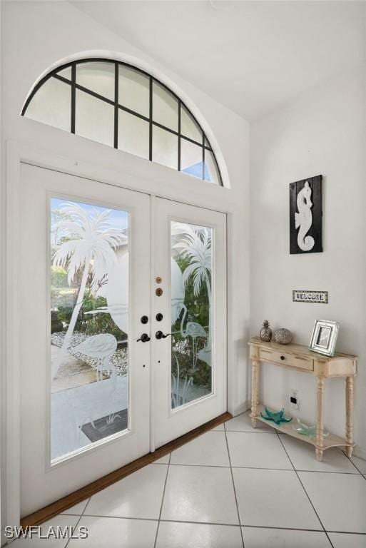 doorway to outside featuring french doors and light tile patterned flooring