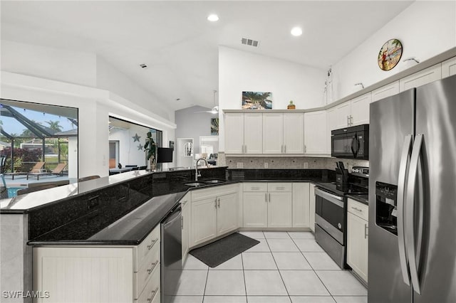 kitchen featuring kitchen peninsula, decorative backsplash, stainless steel appliances, sink, and white cabinets