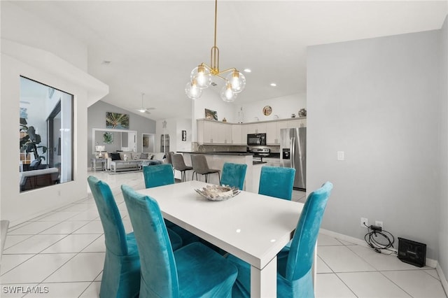 dining area with a chandelier, light tile patterned floors, and lofted ceiling