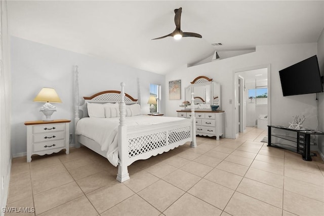 bedroom with ensuite bath, ceiling fan, light tile patterned floors, and lofted ceiling